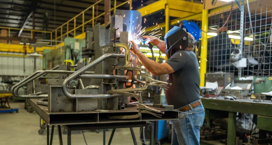 A Ranch Hand fabricator places the 12-guage tube into a jig and welds the grille guard into place